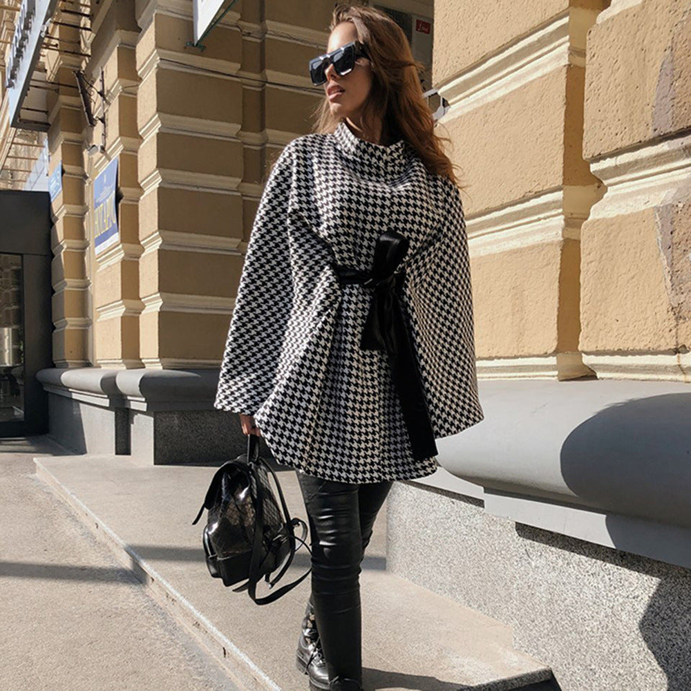 beautiful girl wearing a long black and white  houndtooth small pattern winter coat tgc fashion 